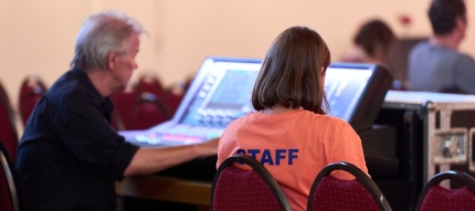 Staff mit Tontechniker am Mischpult